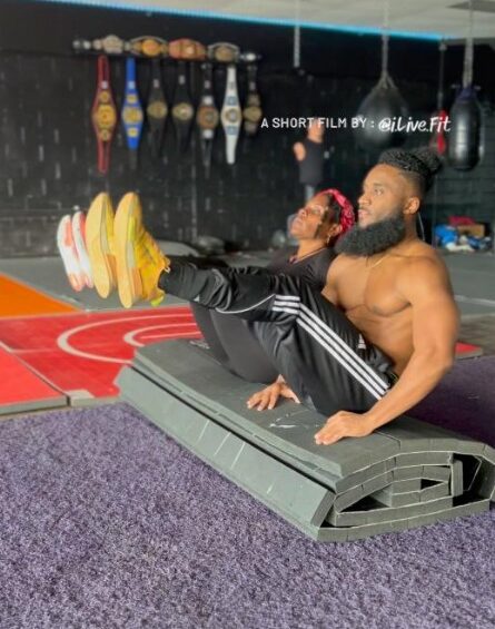 60 year old mom doing ab workout with son in boxing gym