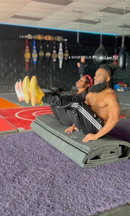 60 year old mom doing ab workout with son in boxing gym